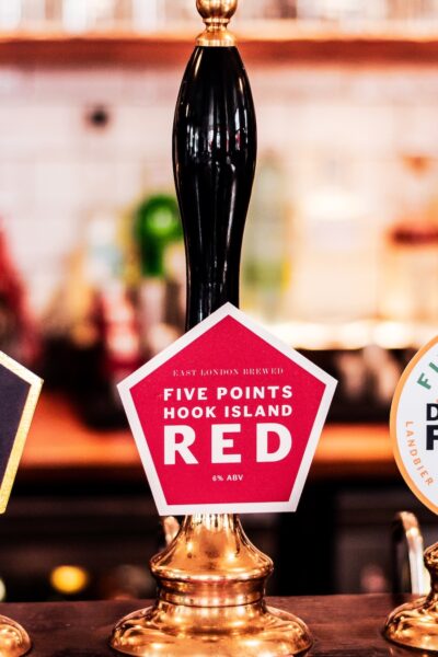 A pump clip features the Hook Island Red on handpull
